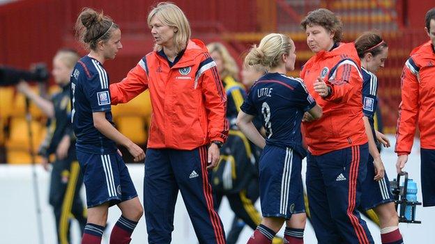 Anna Signeul consoles the Scotland squad after defeat to Sweden