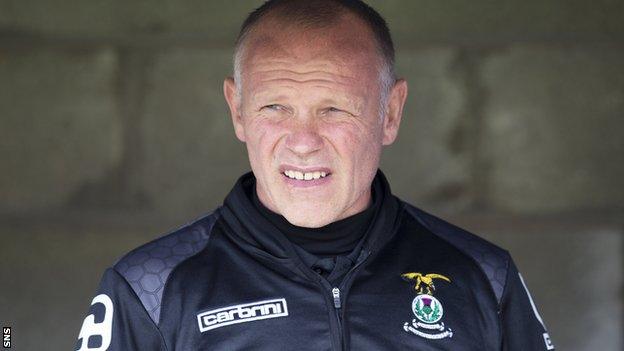 John Hughes surveys the pitch from the Inverness dugout