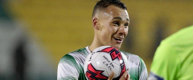 A delighted Graham Burke collects the match ball after his four-goal blast against the Candystripes