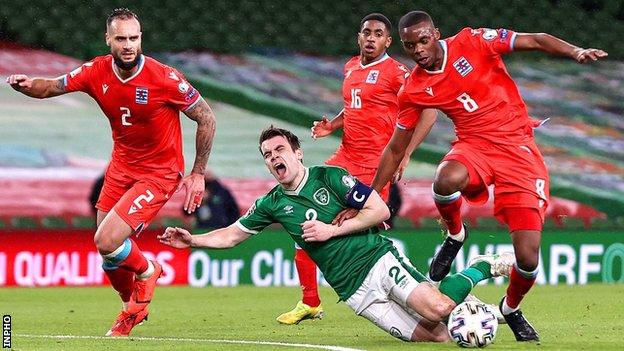 Republic of Ireland captain Seamus Coleman is tackled by Luxembourg's Christopher Martins