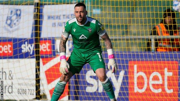 Dean Bouzanis in goal for Sutton United