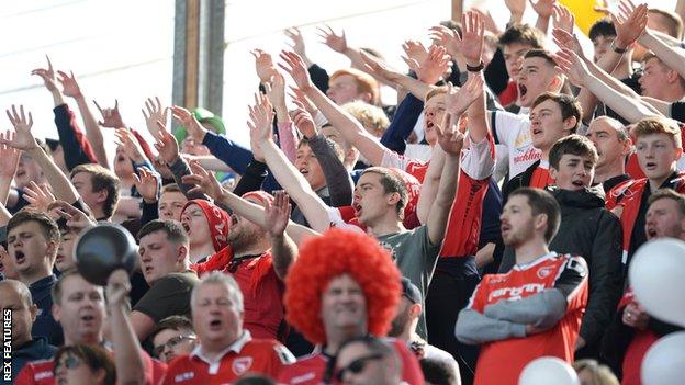 Morecambe supporters cheer at Coventry