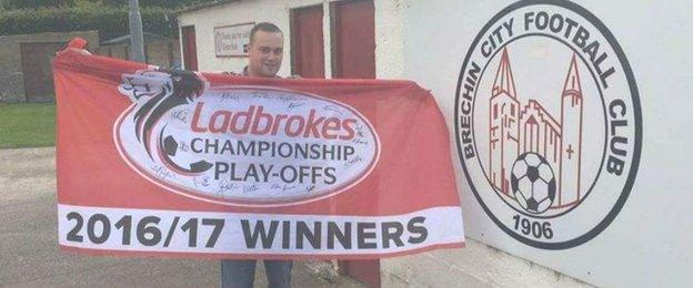 Dean Walker with his Brechin City play-off victory flag