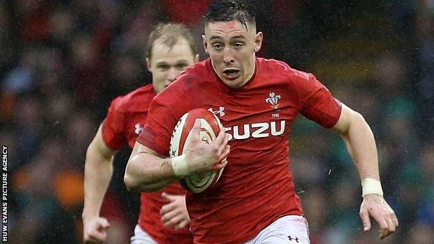 Josh Adams makes a break for Wales against Ireland