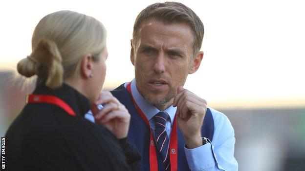 GB and England manager Phil Neville talks to Wales boss Jayne Ludlow