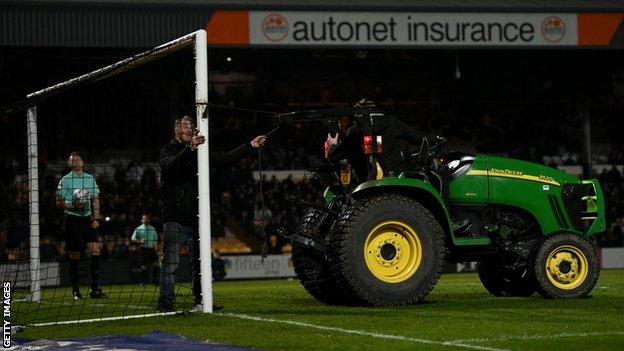 A tractor is used to straighten the post that had been bent out of shape