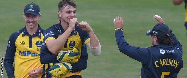 Joe Cooke (centre) celebrates a wicket for Glamorgan