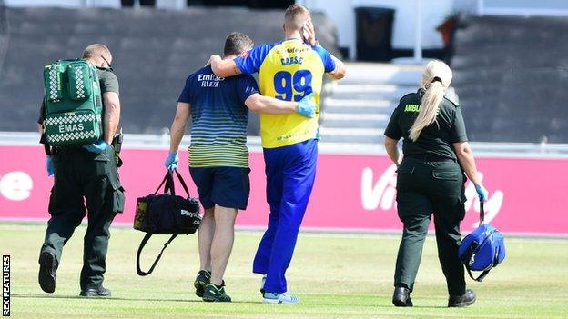 Brydon Carse helped off the pitch