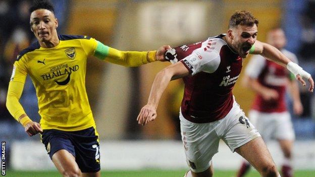 Harry Smith (right) in action for Northampton Town against Sean Clare of Oxford United