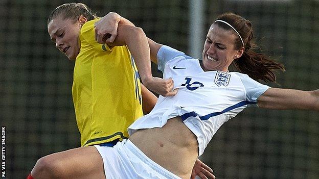 England midfielder Jill Scott tussles for the ball