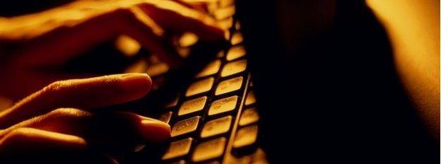 Hands typing on a keyboard