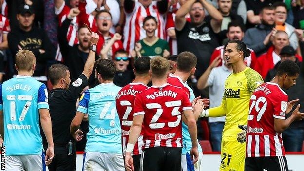 Derby goalkeeper Kelle Roos is sent off