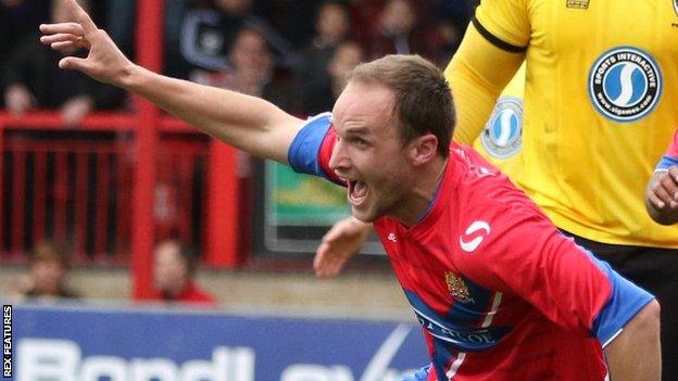 Scott Doe scores against AFC Wimbledon during his previous spell with Dagenham & Redbridge