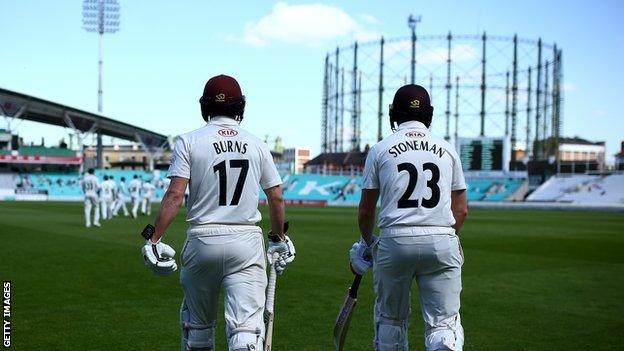 Rory Burns walks out to bat with Surrey opening partner Mark Stoneman