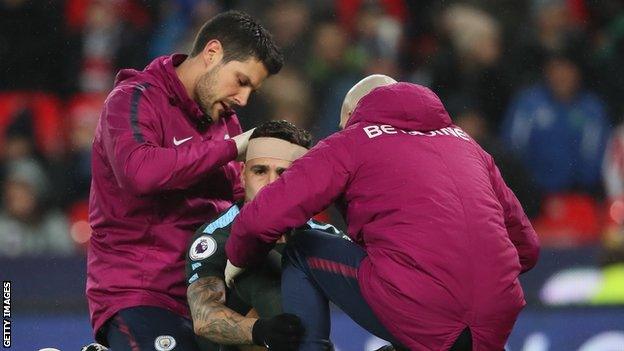 Manchester City's Nicolas Otamendi receives treatment for a head injury