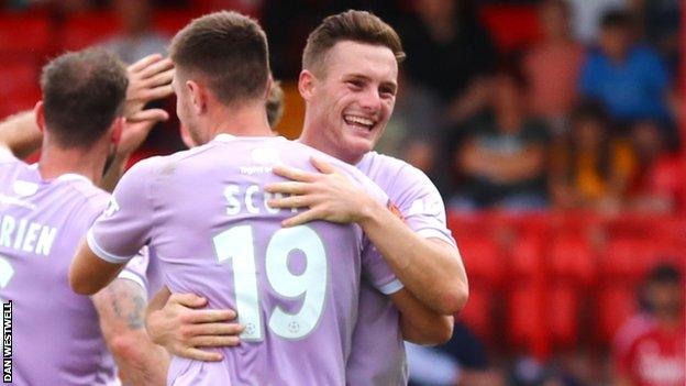 Cedwyn Scott celebrates a goal with Macaualy Langstaff