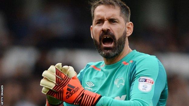 Derby goalkeeper Scott Carson encourages his team-mates