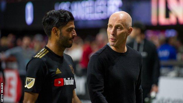 Bob Bradley with former Arsenal forward Carlos Vela