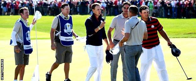 Jordan Spieth and Patrick Reed of the United States shake hands with Sergio Garcia and Rafa Cabrera Bello of Europe