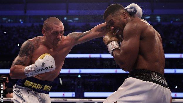 Usyk punches Joshua during their bout at Tottenham Hotspur Stadium in September