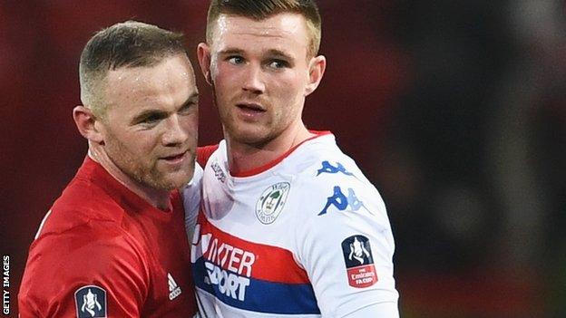 Wigan's Ryan Tunnicliffe (left) up against Manchester United's Wayne Rooney