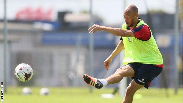 Alex Finney kicks a ball during a training session