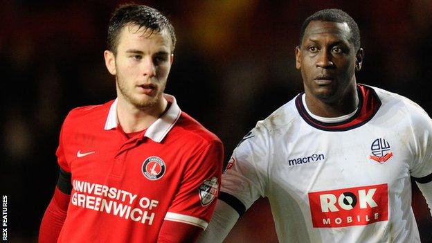 Charlton's Harry Lennon and Bolton's Emile Heskey vie for the ball