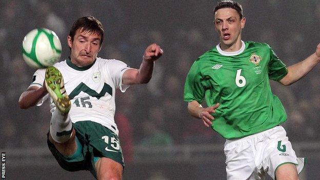 Slovenia's Armin Bacinovic comes under pressure from Chris Biard in the Euro 2012 qualifier in Belfast