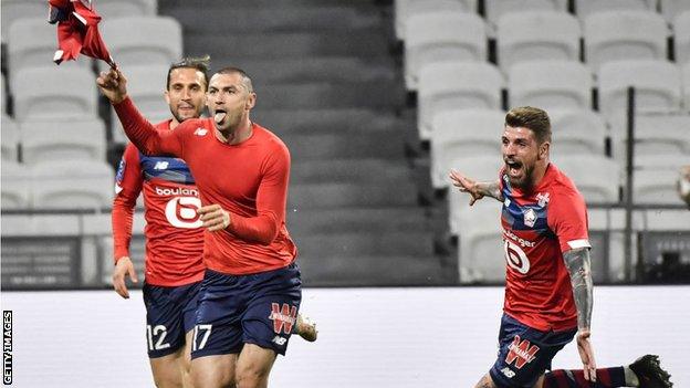 Burak Yilmaz and his Lille team-mates celebrate beating Lyon