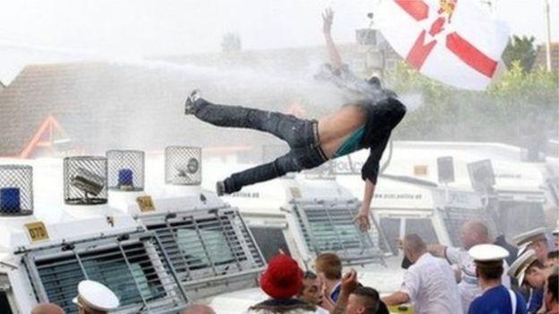 A protester was flung from the roof of a police Land Rover after being sprayed by a police water cannon three years ago