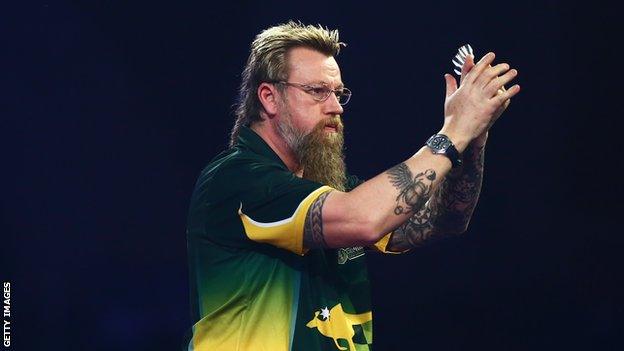 Simon Whitlock applauds the crowd after winning a match