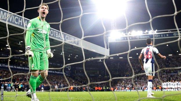 Jed Steer celebrates saving Mason Holgate's penalty