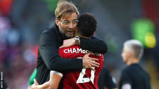 Liverpool manager Jurgen Klopp hugs midfielder Alex Oxlade-Chamberlain