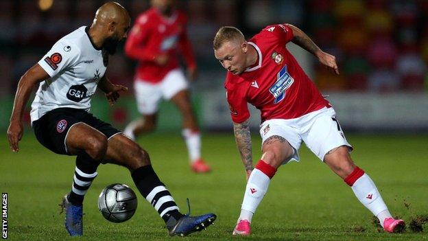 Wrexham's Elliott Durrell takes on Maidenhead goalscorer Josh Coley.