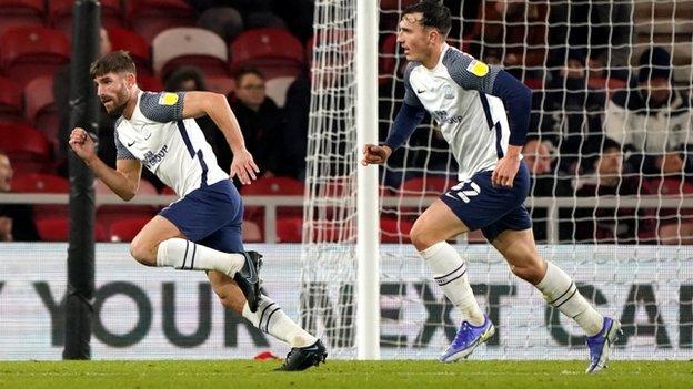 Ched Evans (left) wheels away after scoring for Preston