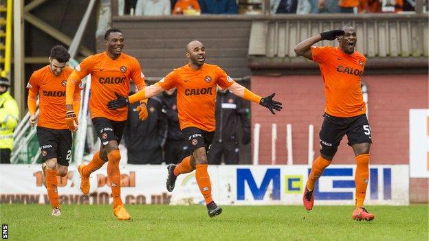 Dundee United players celebrate Guy Demel's opening goal in their win over Hearts