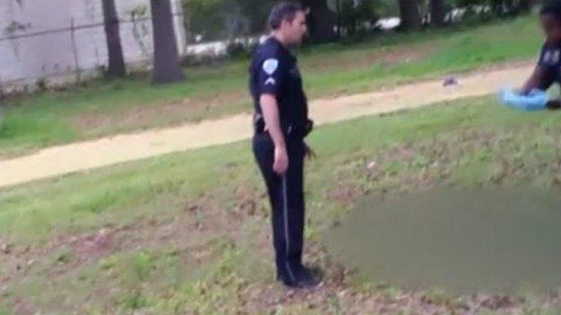 Mr Slager and another officer stand over the body of Mr Scott after the shooting