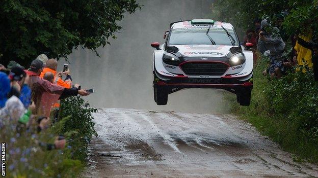 Elfyn Evans' car takes off over a jump during the Orlen Rally in Poland