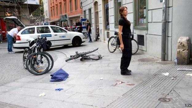 Police investigators stand at the scene where an SUV drove into pedestrians in the city centre of Graz, Austria, 20 June 2015