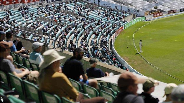 Spectators watch cricket