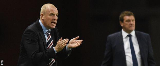 Mark Warburton urges his Rangers players on as Tommy Wright watches