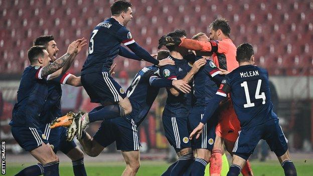 Scotland goalkeeper David Marshall is mobbed by delighted team-mates