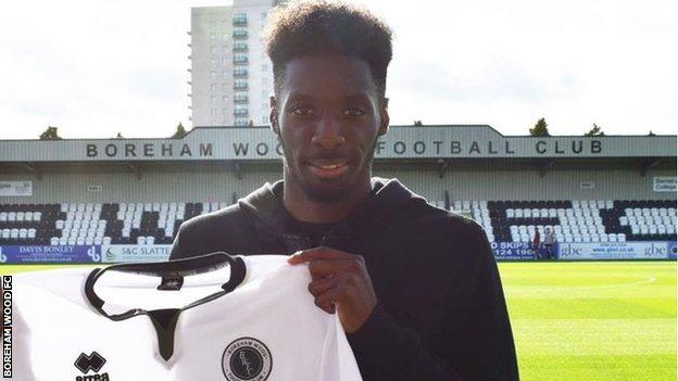 Turgott holding a Boreham Wood shirt
