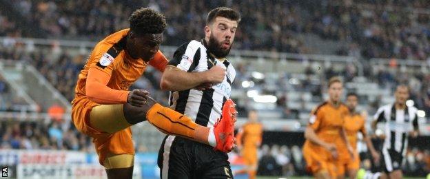 Grant Hanley contests a ball for Newcastle against Wolves in the EFL Cup