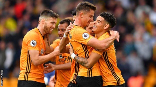 Wolves players celebrate their first win of the Premier League season