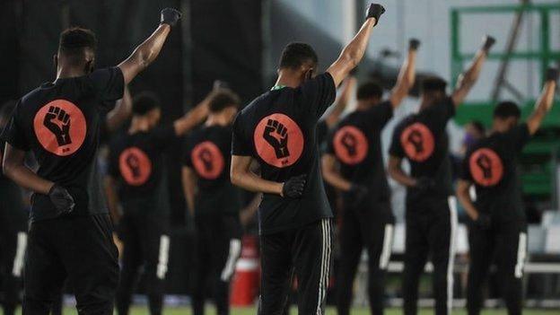 Players raised a fist to the sky as part of their protest