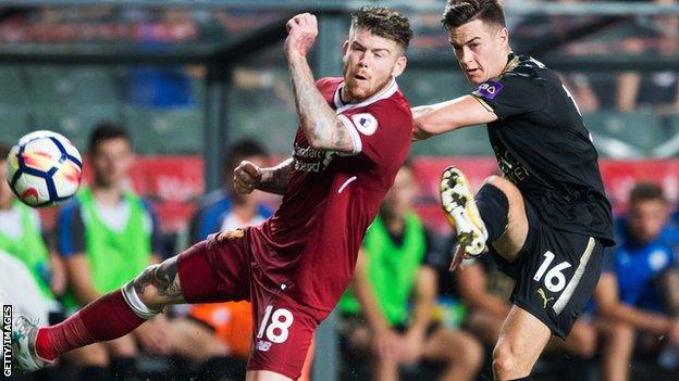 Liverpool's Alberto Moreno (L) and Leicester City's Tom Lawrence (R) compete for the ball during the final of the Premier League Asia Trophy