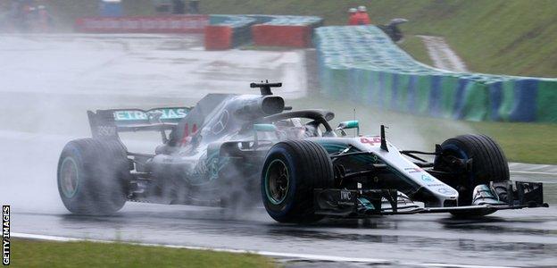 Lewis Hamilton takes pole position for the Hungarian Grand Prix in wet conditions