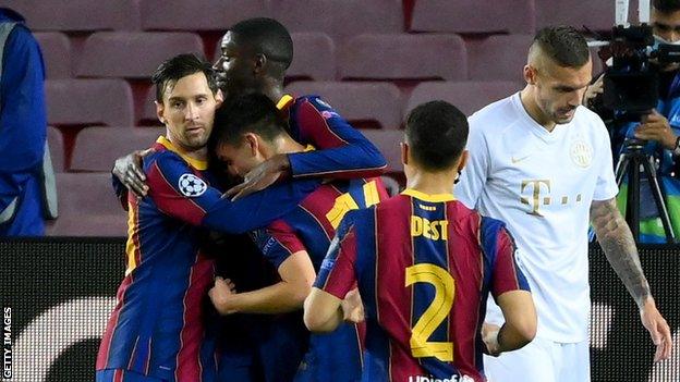 Lionel Messi (left) congratulates Pedri on scoring