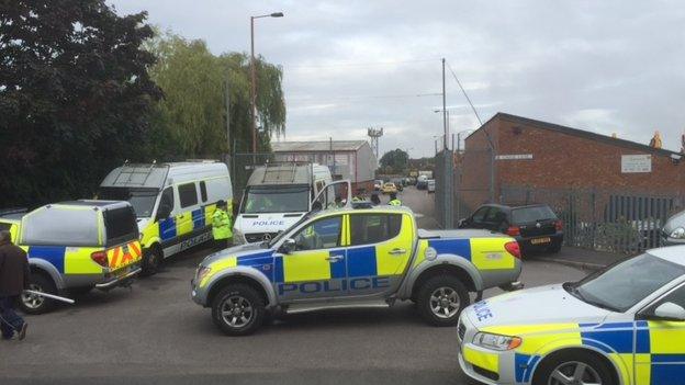 Police vehicles at the community centre